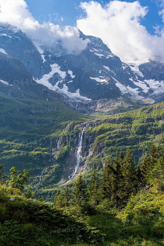 Schmadribachfall waterfall and picturesque mountain landscape with Breithorn mountain peak, Bernese Alps, Bernese Oberland, Switzerland