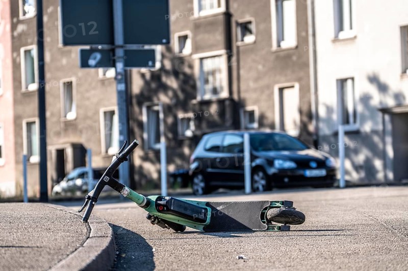 Rental scooter, e-scooter, left at the sidewalk, in Essen, North Rhine-Westphalia, Germany