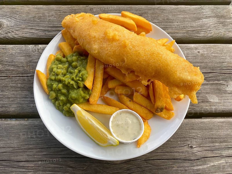 Fish and chips, fried fish in batter, french fries, pea puree, remoulade, lemon, on a plate, food, London, Great Britain, Great Britain