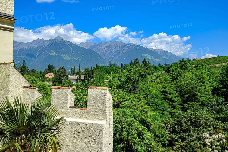 View from Trauttmansdorff Castle, home of the South Tyrolean State Museum of Tourism, of the surrounding alpine landscape of Merano, Burggrafenamt, South Tyrol, Italy