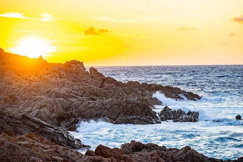 Landscape of the coastline with blue water at Marinedda Coast at sunset, Sardinia, Italy