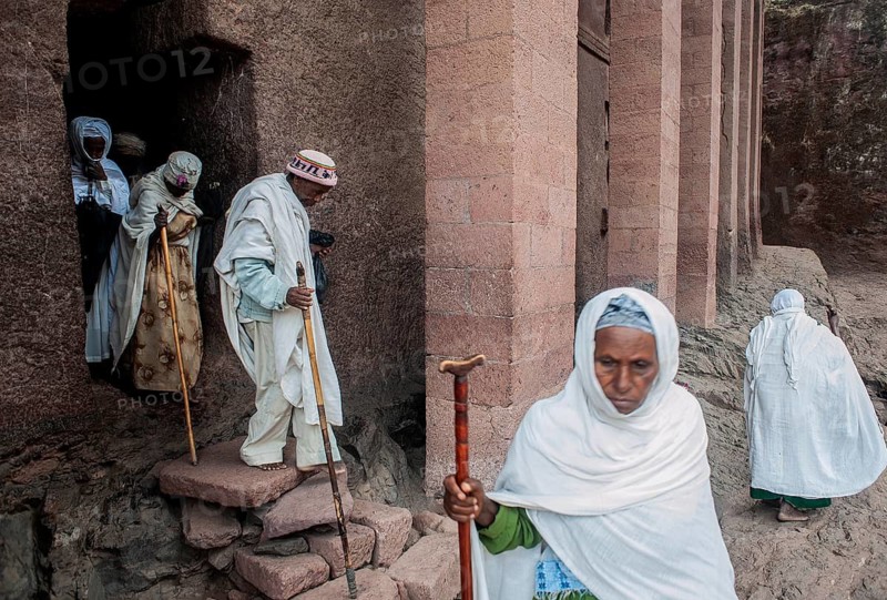 Faithful getting out of a rock hewn church at Lalibela, Ethiopia. Major centre of the orthodox christian faith in Ethiopia