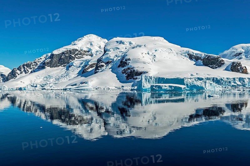 Snow-capped peaks and glaciers reflected in calm waters, Gerlache Strait, Antarctica