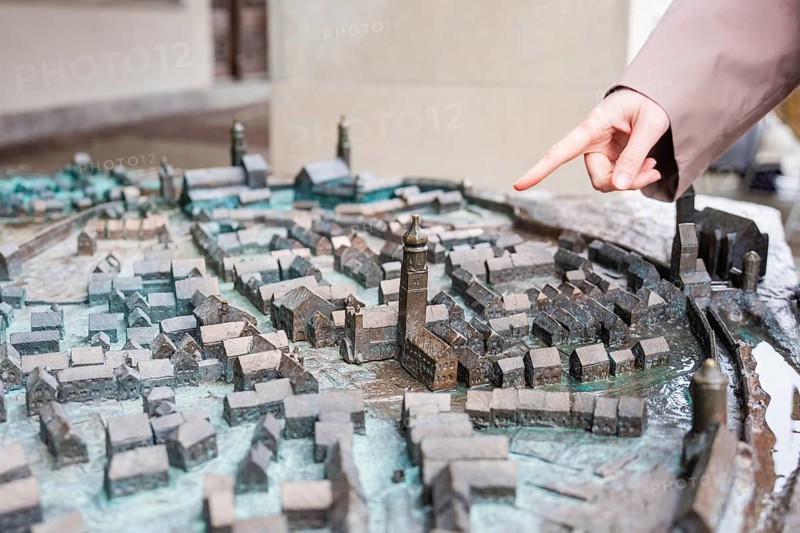 Close-up of a city model with hand pointing at buildings, Isny, Allgäu, Bavaria, Germany