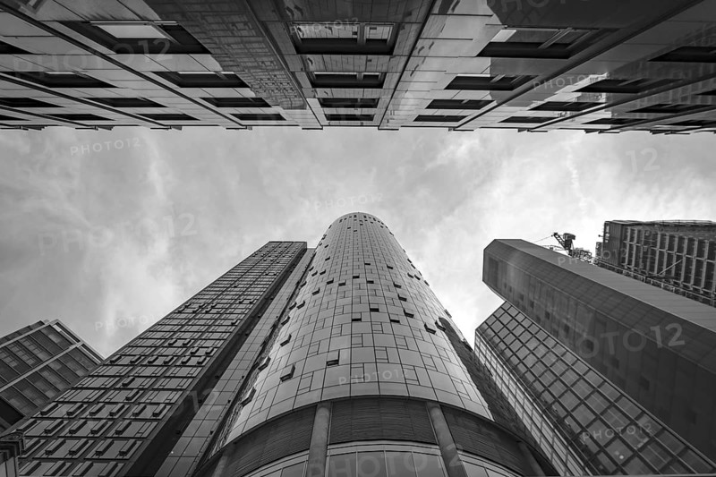 Drmatic black and white image of tops of skyscrapers with main observation tower in the middle, Frankfurt city, Germany