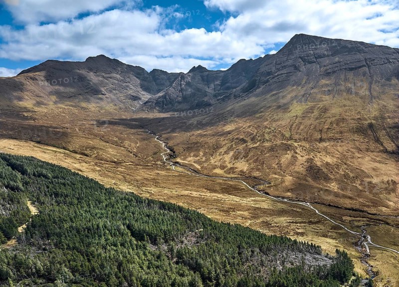 Aerial panoramic drone photo landscape of the Black Cuillins mountain chain with the tourist attraction of the fairy pools, Isle of Skye, Scotland, UK
