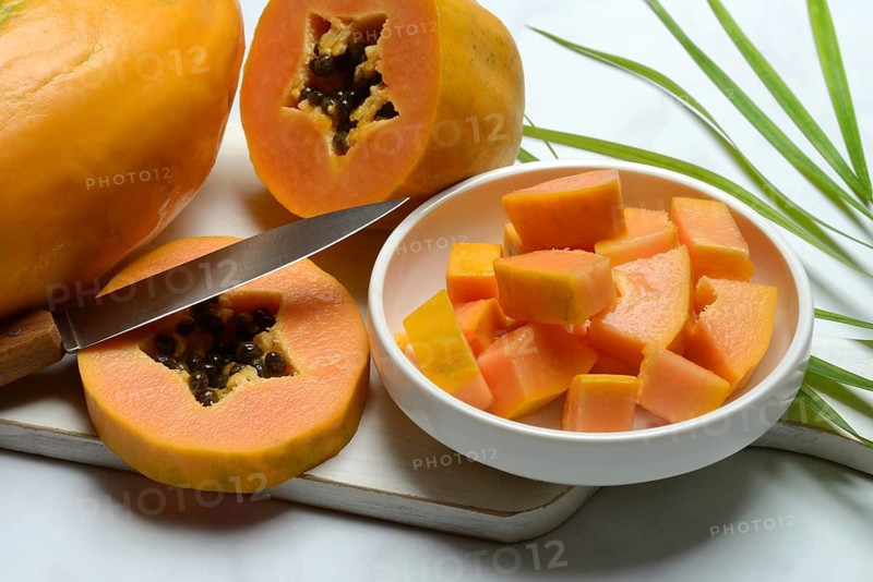 Pawpaw, split fruit in skin, halved and whole fruit, Carica papaya