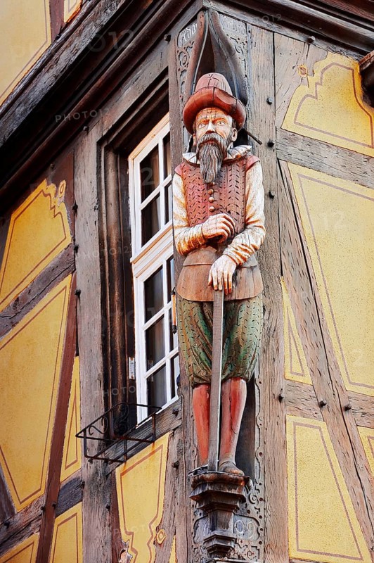 Merchant sculpture at Maison Zum Kragen timbered house, wood carving, Colmar, Haut-Rhin, Alsace, Grand Est, France