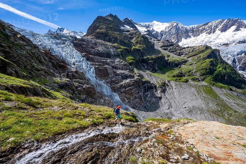 Mountaineers in front of mountain panorama, picturesque high-alpine mountain landscape with Lower Arctic Sea glacier and Grindelwald-Fiescherfirn glacier, hiking to Schreckhornhütte, Bernese Oberland, Switzerland