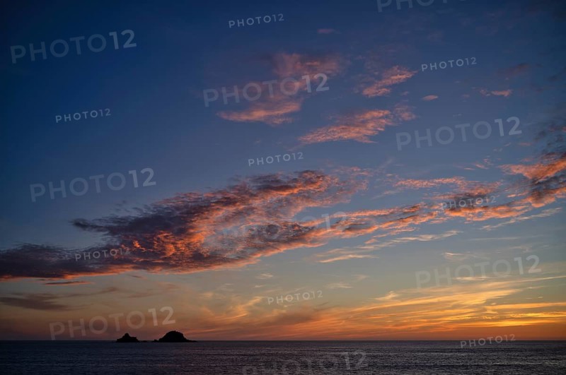 Sunset, sunset at sea, dramatic clouds, in the background rock formation The Brisons, Cot Valley Beach, Porth Nanven, coast, St Just in Penwith, Cornwall, England, Great Britain, Great Britain