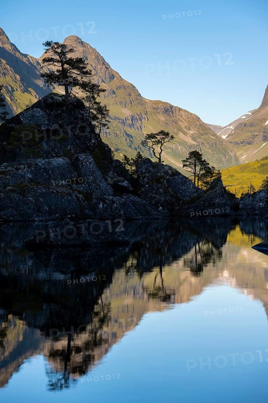 Picturesque mountain landscape in the Innerdalen high valley, silhouettes in front of mountain peaks, reflection in Lake Innerdalsvatna, Trollheimen Mountain Area, Sunndal, Møre og Romsdal, Norway