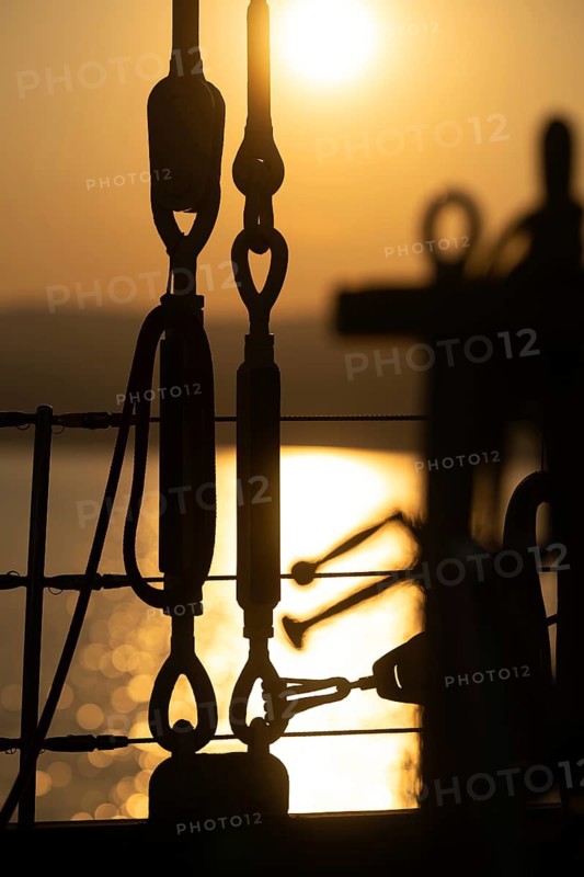 Part of the rigging of a sailing ship, anchoring, steel cables, back light, sunset, silhouette, bokeh effect, Sicily, Italy