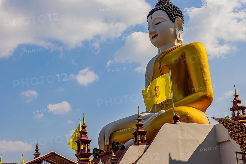 Huge gilded sitting Buddha, in front of the Wat Phra That Doi Kham Buddhist temple complex, Chiang Mai, Thailand