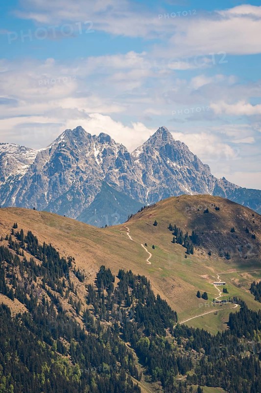Two high mountain hills with a visible hiking trail through the green countryside, Hahnenkamm, Kitzbühel, Austria
