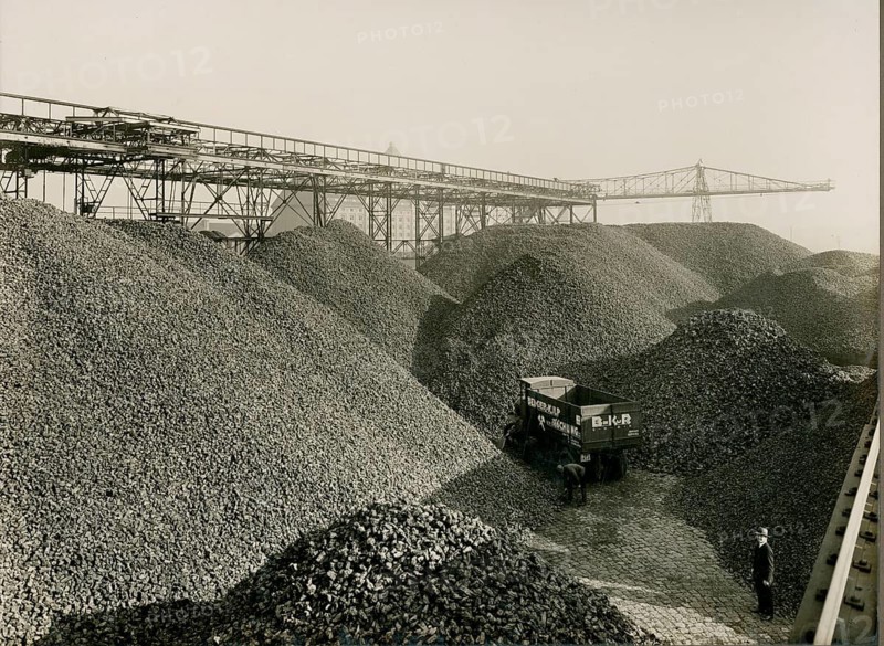 Berlin, Westhafen, Moabit, coal piles, coke, Berger-Kulp Röchling, Huttenstraße, wholesale, fuel, truck, crane system, landscape full of coal hills with a truck next to a conveyor belt in an industrial environment, walleye, Labisch, photographer studio, Jewish, around 1930