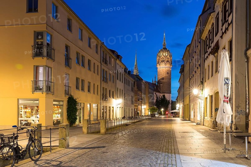 Coswiger Straße in the evening with castle church tower, Luther city Wittenberg, Saxony-Anhalt, Germany