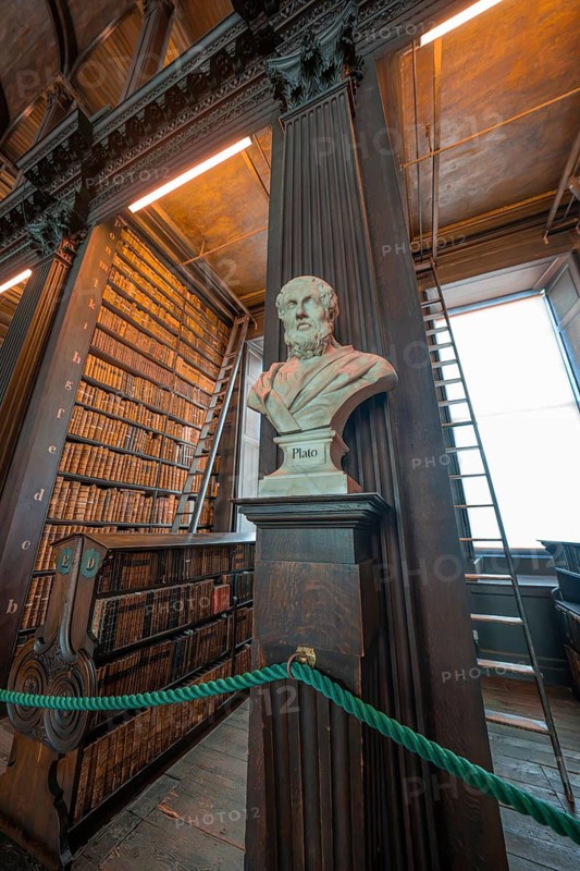 Bust of Plato in a historic library with bookshelves, Trinity Collage, Dublin, Ireland
