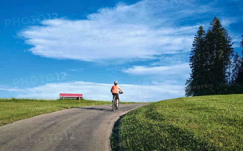 Active senior woman rides her electric mountain bike in Westallgäu near Lindenberg, Bavaria, Germany