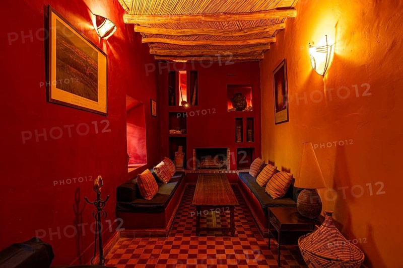 Orientally furnished interior with traditional wooden ceiling, with seating in a riad, the walls are made of Tadelakt lime plaster, Marrakech, Maghreb, Morocco, North Africa