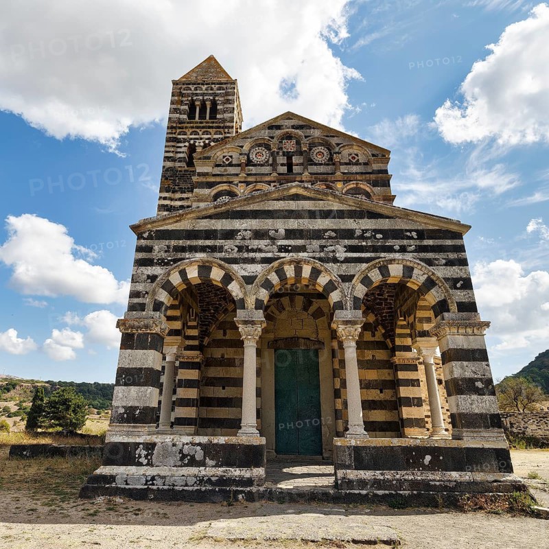 Distinctive black and white striped limestone and basalt façade, Santissima Trinità di Saccargia abbey church, former Camaldolese monastery, landmark, Logudoro, Sassari, Sardinia, Italy