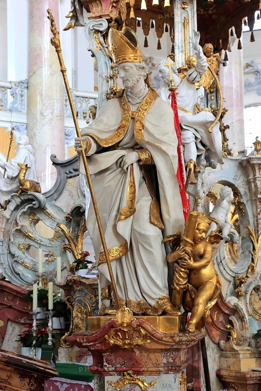 One of the emergency workers at the Altar of Mercy in the Vierzehnheiligen Basilica, Bad Staffelstein, Lichtenfels district, Upper Franconia, Bavaria, Germany. The church, built according to plans by Balthasar Neumann, is dedicated to the fourteen emergency workers