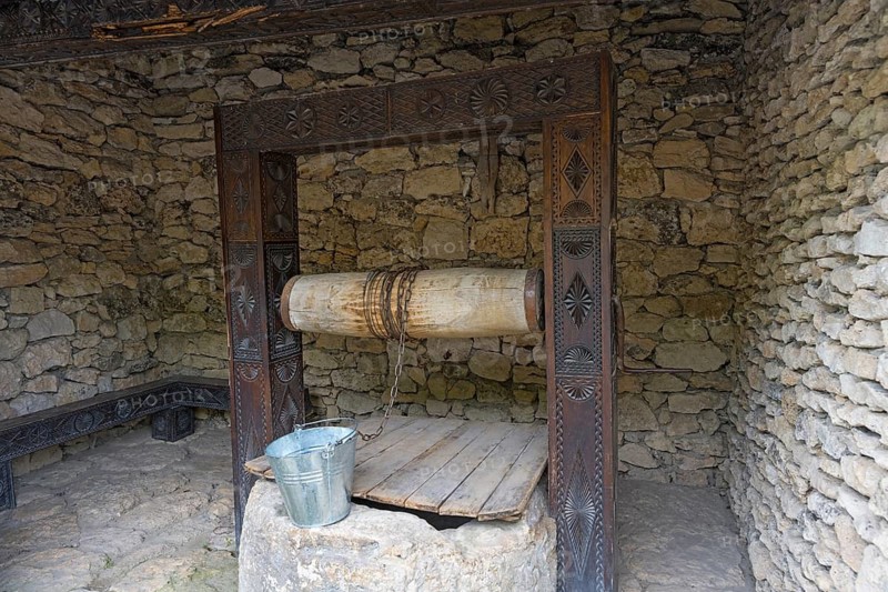 Rustic stone well with bucket in a walled area, historic well, Butuceni, Old Orhei, Orheiul Vechi, archaeological site, historical-landscape reserve, Orhei district, Republic of Moldova, Moldova