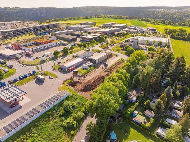 Aerial view of a commercial area surrounded by green landscape, Parkhaus Bau, Calw, Germany