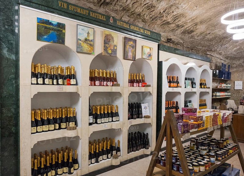 Shelves with sparkling wine bottles and paintings in a decorative cellar area, sales room, Milestii Mici Winery, Mile?tii Mici, Republic of Moldova, Moldova