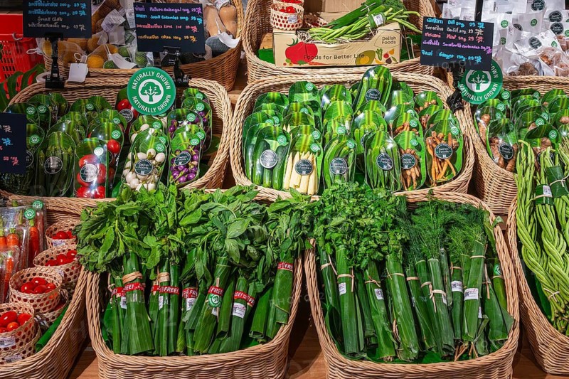 Vegetable and herb sales rack wrapped in banana leaves, Bangkok, Thailand