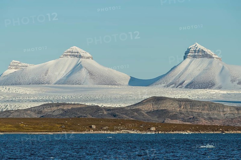 A fjord with ice floes and two of the three mountains: Tee Kroner (Three Crowns), Kronebreen or Kronengletscher Glacier, Kongsfjord or Kongsfjorden, the Svalbard archipelago, Svalbard, Norway