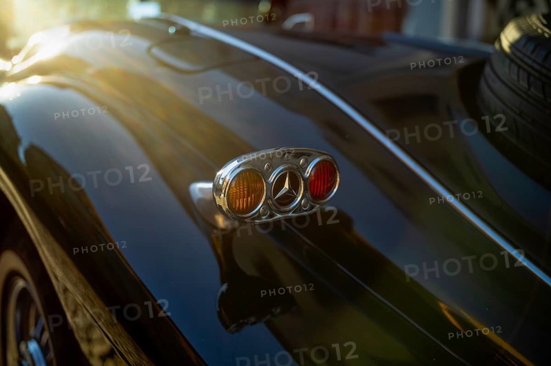 Close-up of rear light indicator with Mercedes logo Vintage Mercedes-Benz 500 K Special Roadster 1936 (internally W29) Sindelfingen bodywork on a black wooden frame Luther city Wittenberg, Saxony-Anhalt, Germany