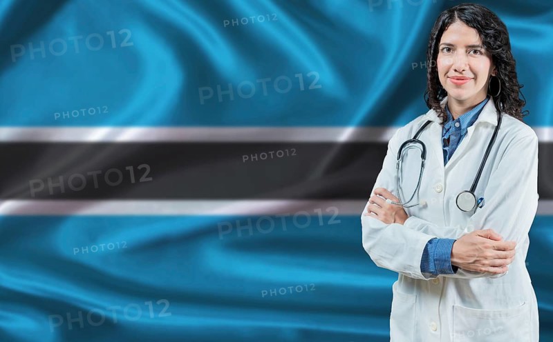 Botswanan medicine and healthcare concept. Doctor close up against Botswana flag background