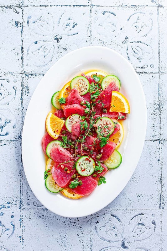 Sicilian tuna crudo, on a white plate, Italian dish, homemade, no people