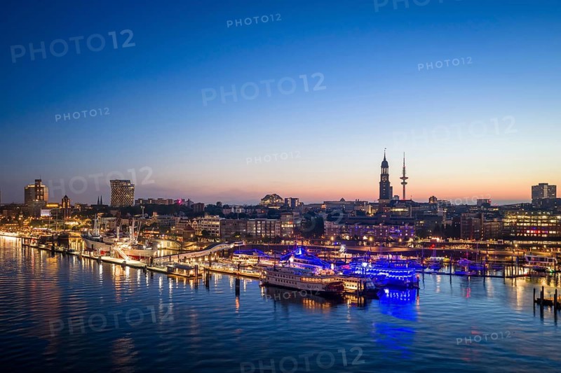 Aerial view of Landungsbrücken at sunrise on the Elbe with St Michael's Church (Michel) and Heinrich Herz Tower, Hamburg, Germany