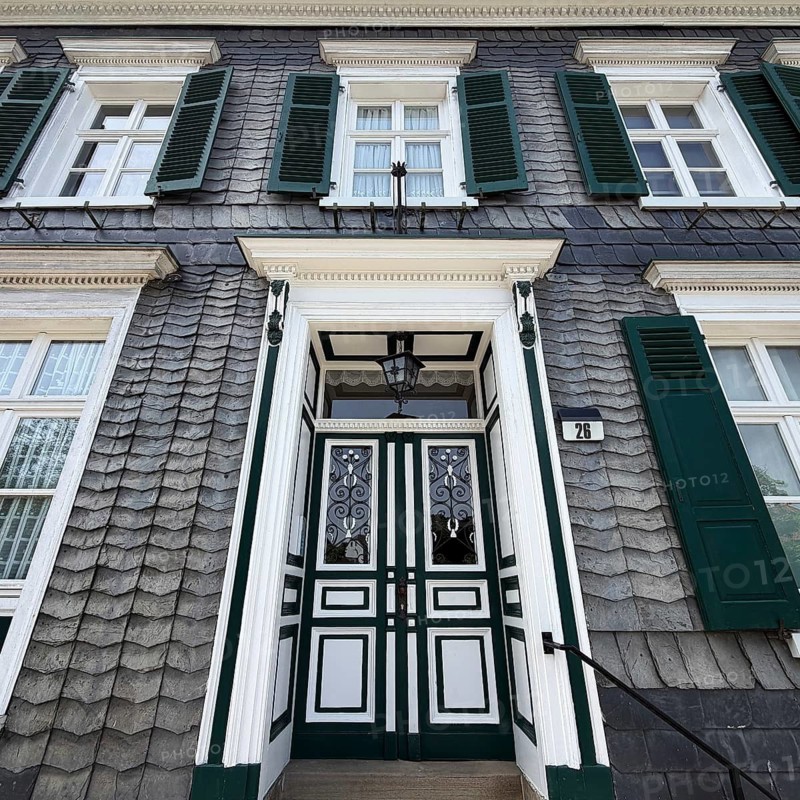 Beautiful front door with slate façade and green shutters, Bergischer Dreiklang, Hückeswagen, Bergisches Land, Germany