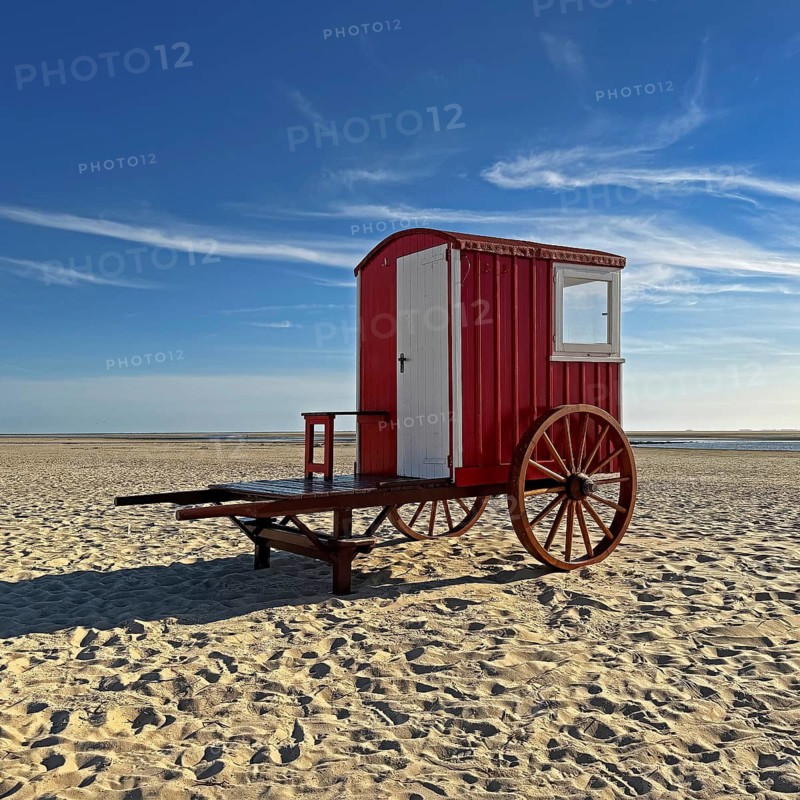 A red bathing cart on the west beach with the sea, North Sea island of Borzburg, East Frisia, Lower Saxony, Germany