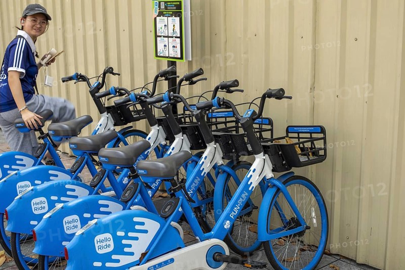 A series of Hello PunPun rental bikes, the blue and white wheels are properly available and show the modern, app-based bike sharing in the historic city center, station in the Phra Nakhon district, Bangkok, Thailand