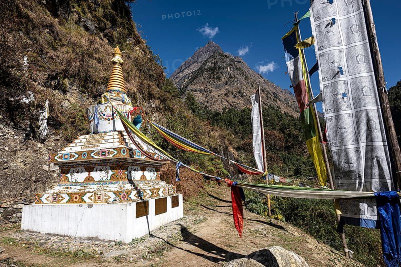 Sacred Buddhist stupa, including choirs with prayer flags on the way to the Tsum Valley, Himalayas, Nepal