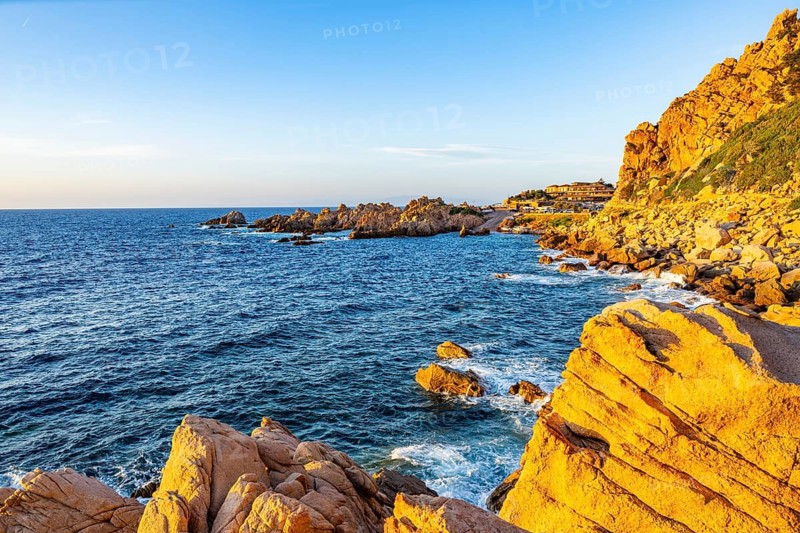 Landscape of the coastline with blue water at Costa Paradiso on a sunny day at sunset, Sardinia, Italy