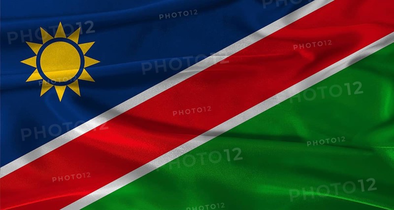 Flag of Namibia with fabric textured background. Close up of National flag of Namibia with realistic texture