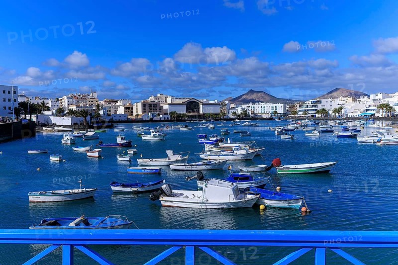 Lanzarote, Canary Islands, Spain, Europe, Charco San Gines harbour area in Arrecife, coastal town with many boats in a quiet harbor, blue bridge in the foreground
