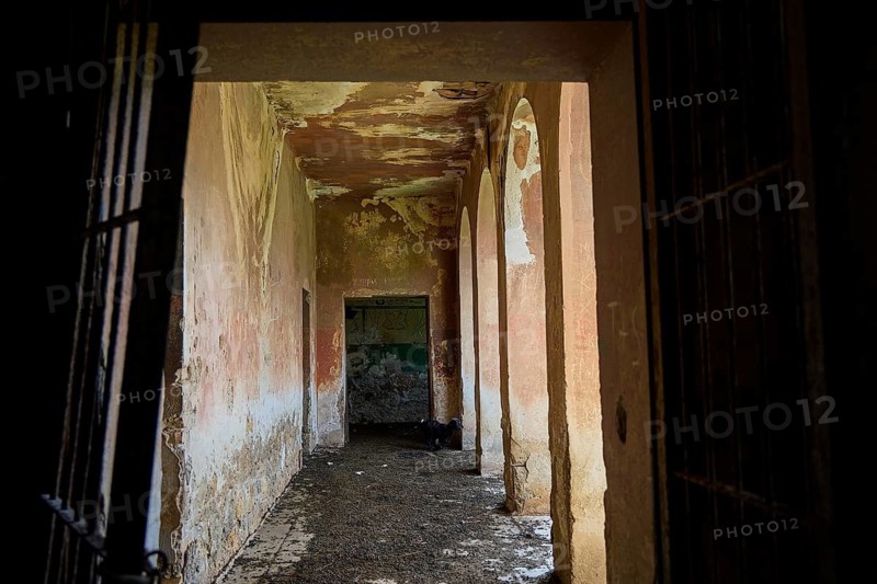 An old abandoned corridor with peeling paint and arches in a historic building, Lost Place, Tourtouras Mountain, Coastal Battery, WW2, World War II, German Coast Battery PL 388, Marine Artillerists, Diapori, Xirokambos, Leros, Dodecanese, Greek Islands, Greece