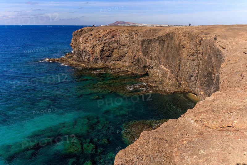 Lanzarote, Canary Islands, Spain, Europe, Playas de las Papagayo, steep cliffs rise above the turquoise sea, the sky is clear and blue
