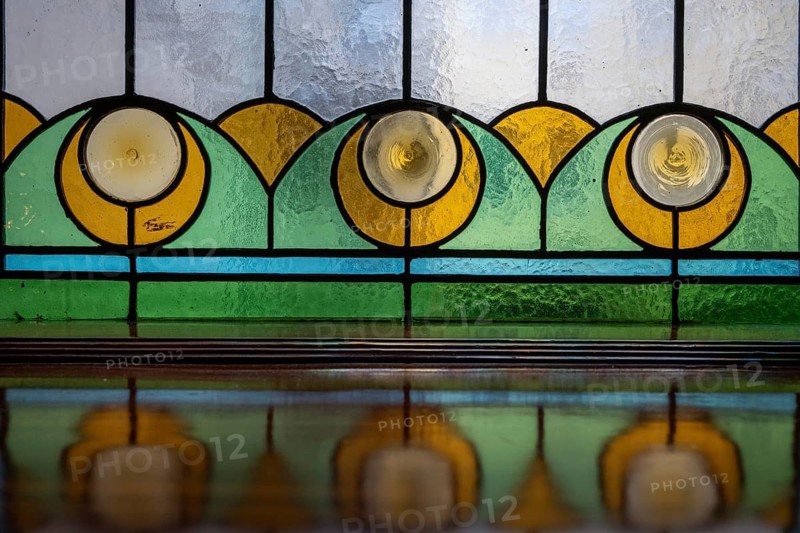 Stained-glass windows (lead-glazed windows), featuring motifs inspired by the Norwegian coastal landscape, in the Art Nouveau stairwell of the Svaneapoteket pharmacy, at the Jugendstilsenteret og KUBE museum, Ålesund or Alesund, Møre og Romsdal County, Norway