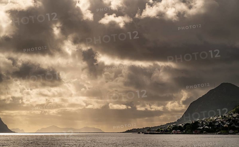 Dramatic lighting and dark clouds over the sea, islands, near Ålesund or Alesund, Møre og Romsdal county, Norway