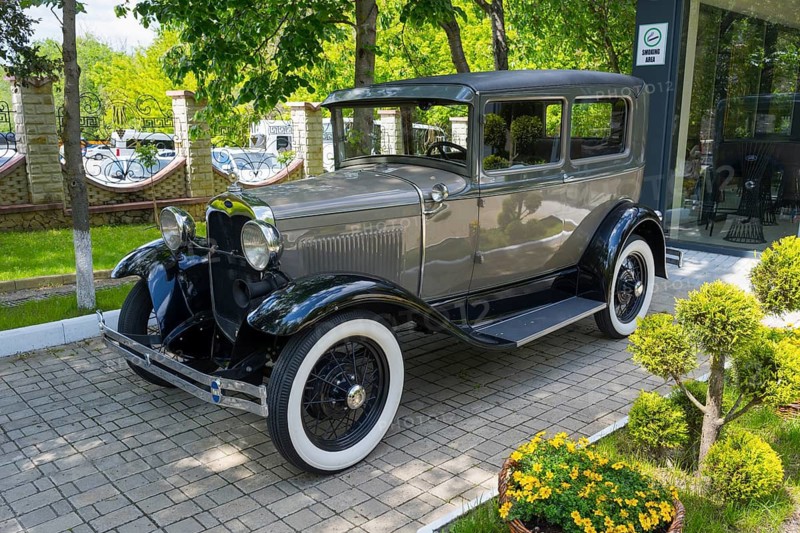Elegant gray classic car on paving stones in a green park, vintage car, Ford Model A, Milestii Mici Winery, Mile?tii Mici, Republic of Moldova, Moldova