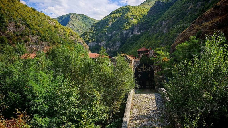 Access to the Archangel Monastery, Sveti Arhangeli, valley view with vegetation, a bridge and a hidden monastery in a mountainous landscape, Orthodox Church, Prizren, Kosovo