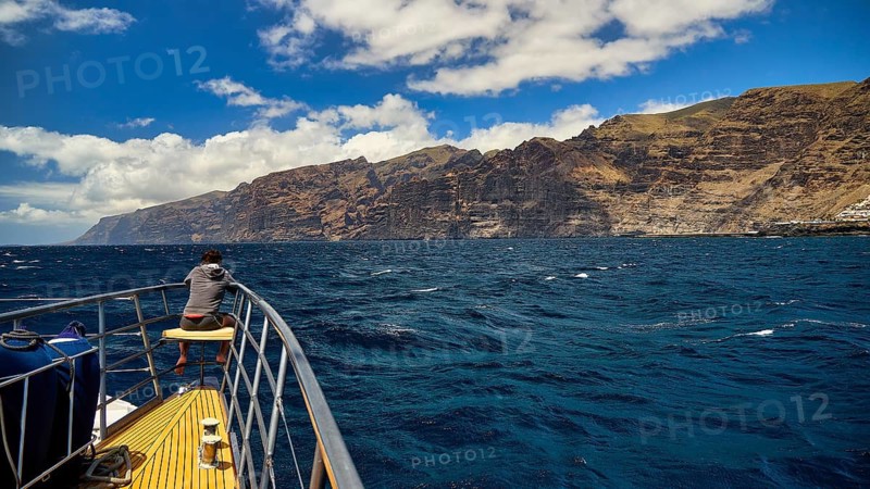Los Gigantes, person leaning on boat sailing towards the impressive rocky coast, whale watching boat tour, whale watching, dolphins, west coast, Tenerife, Canary Islands, Spain