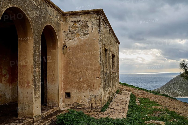 Dilapidated building overlooking the sea, characterized by arches, under a cloudy sky, Lost Place, Tourtouras Mountain, WW2, World War II, German coastal battery PL 388, marine artillerymen, Diapori, Xirokambos, Leros, Dodecanese, Greek Islands, Greece