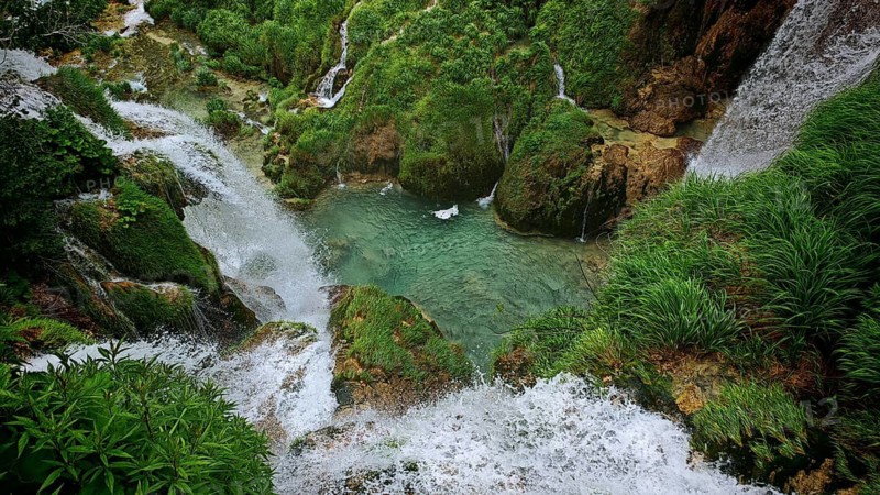 View from above of bubbling waterfalls and a clear pond, Plitvice Lakes National Park, Croatia